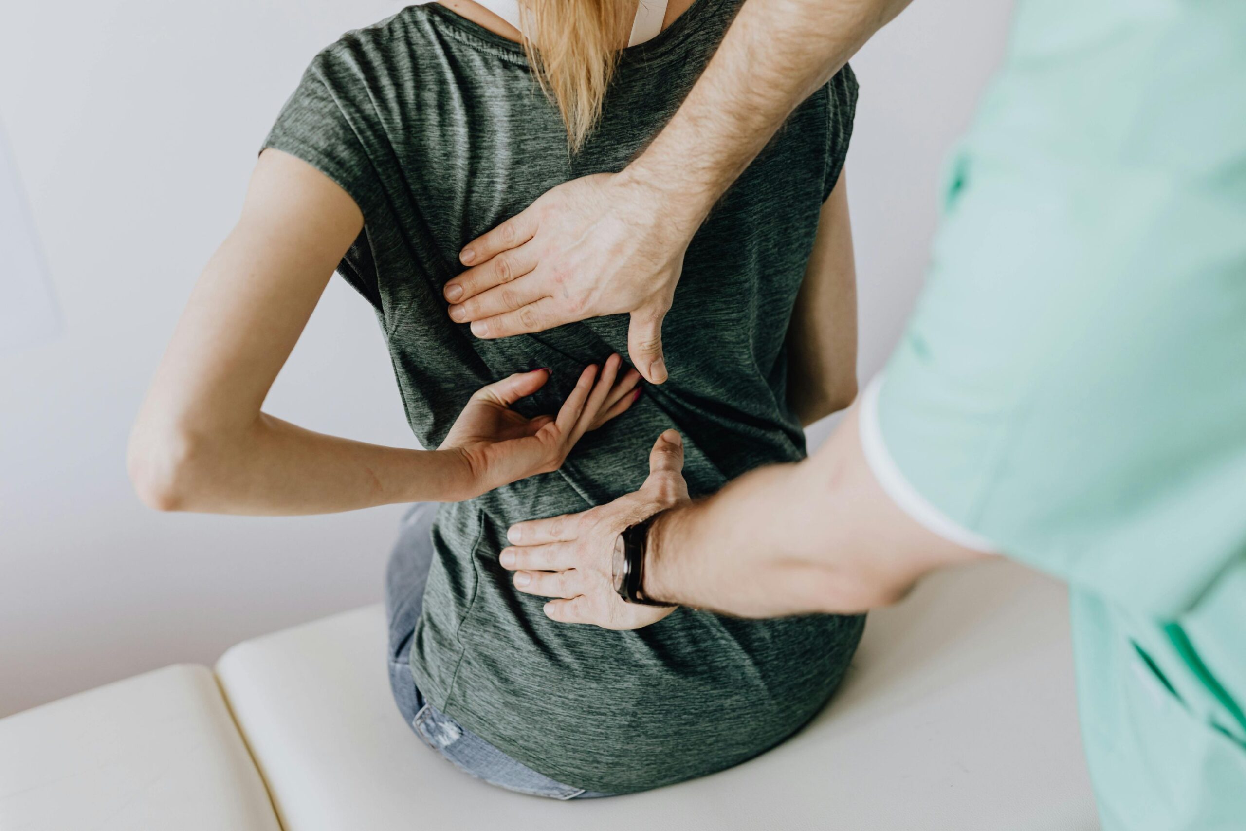 Physical therapist checking range of movement of patient arm and shoulder