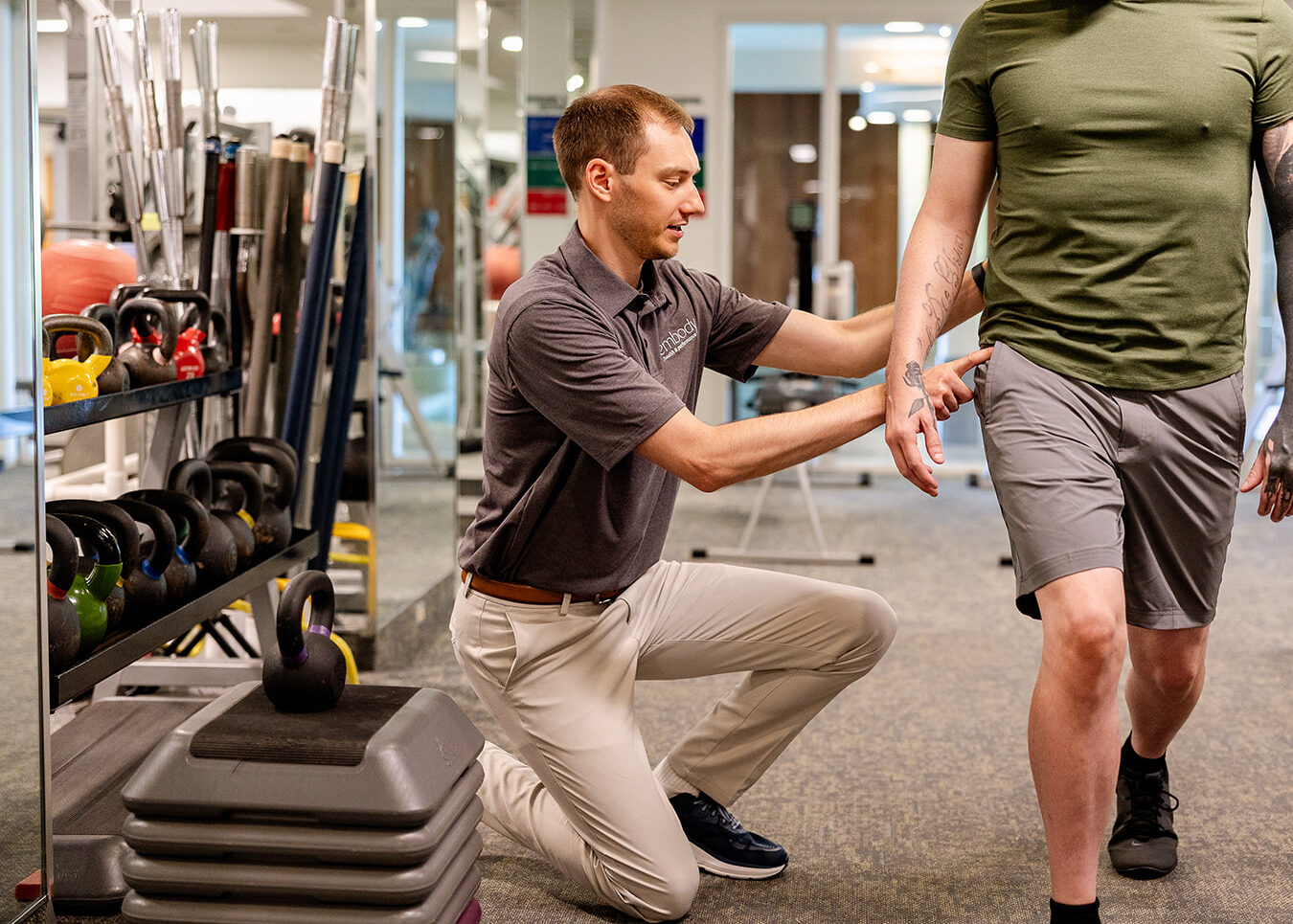 Physical therapist coaching client in clinic