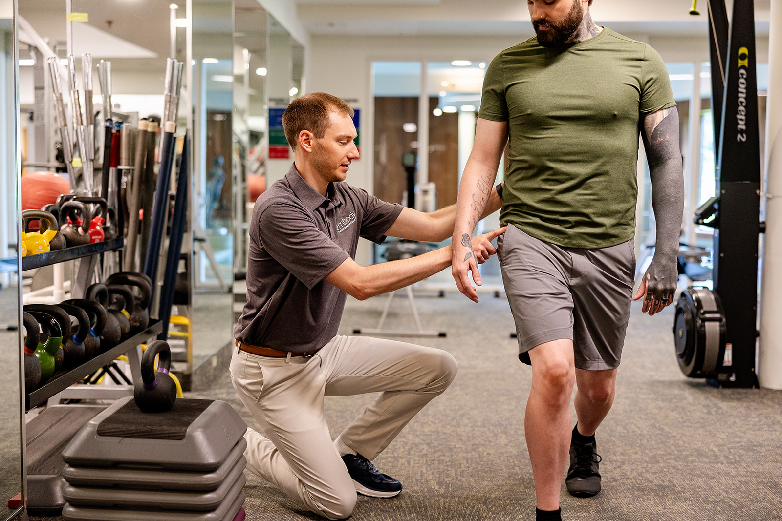 Physical therapist coaching client in clinic
