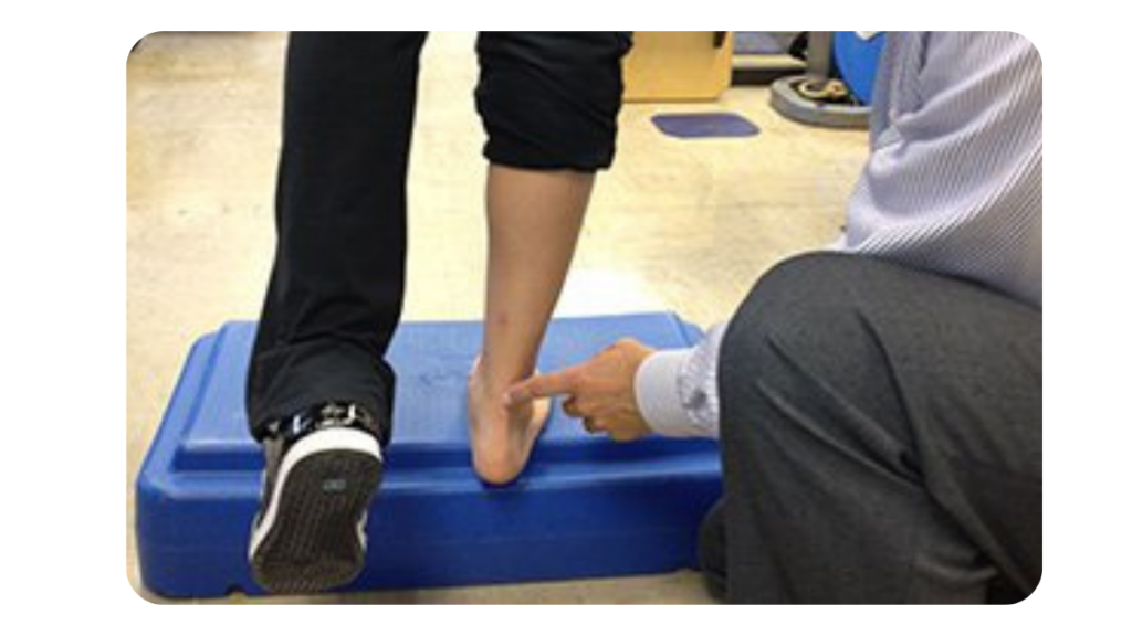 A physical Therapist at Embody Health and Performance Treating Achilles Tendonitis