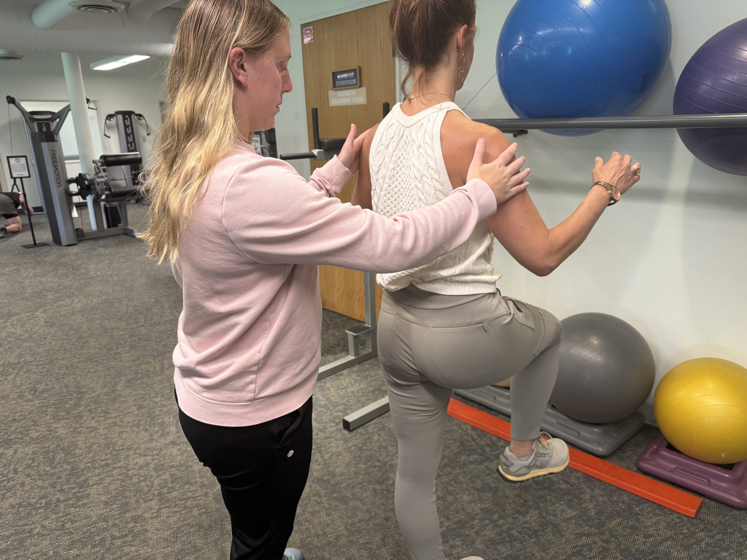 Physical therapist guiding an individualized rehab session at Embody Health and Performance in Minnetonka
